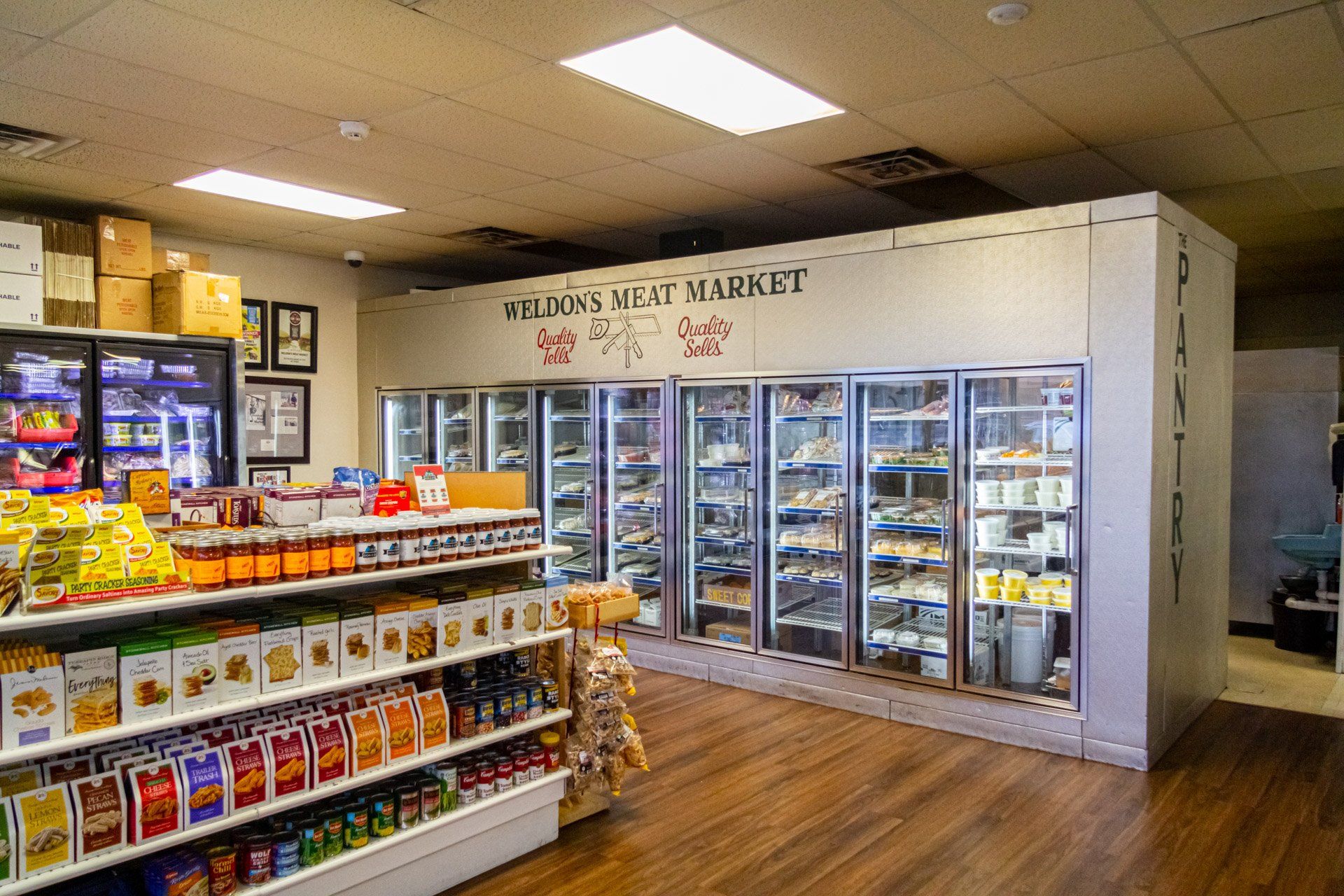 A grocery store with a lot of shelves and refrigerators.