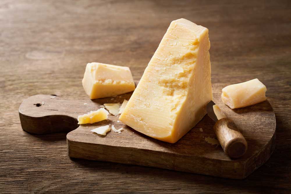 Parmigiano Reggiano cheese on a wooden board