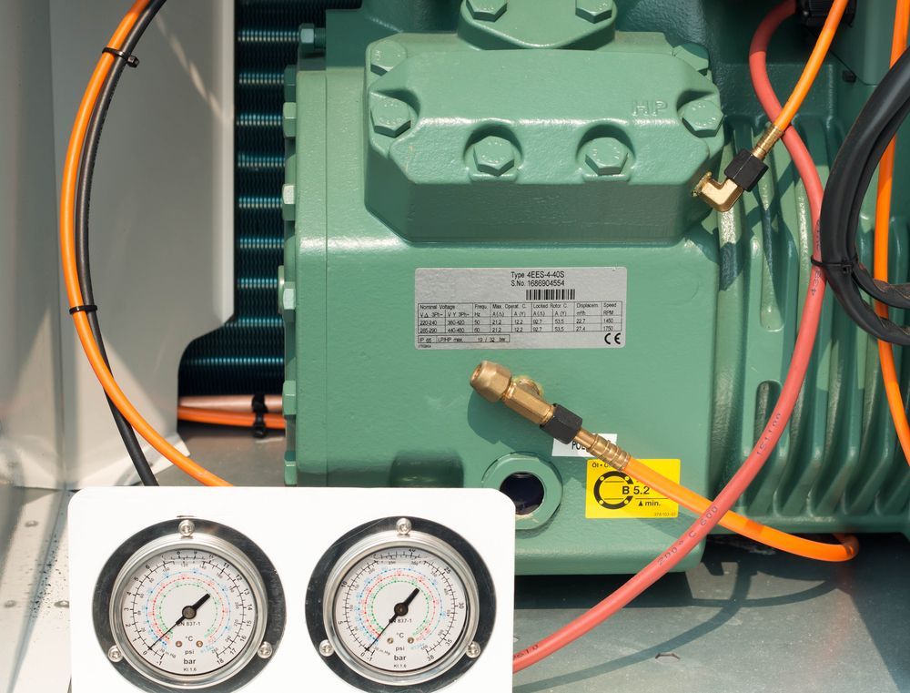 A Green Machine With Two Pressure Gauges Attached To It — Vertex Refrigeration & Air Conditioning Pty Ltd In Cannonvale, QLD