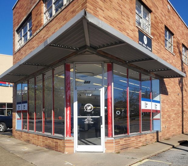 A brick building with a sign that says ' a & a ' on it