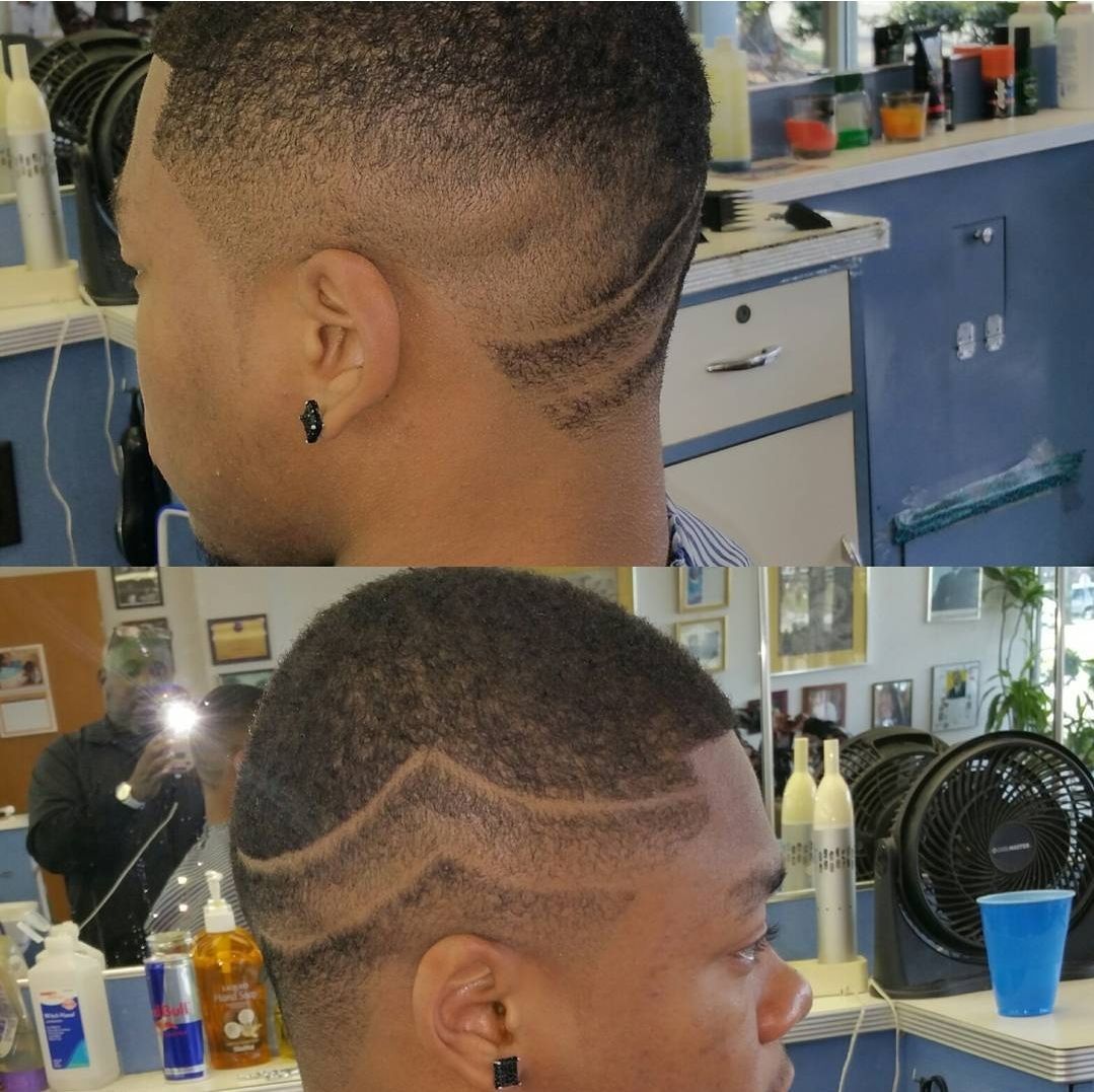 A man is getting his hair cut at a barber shop