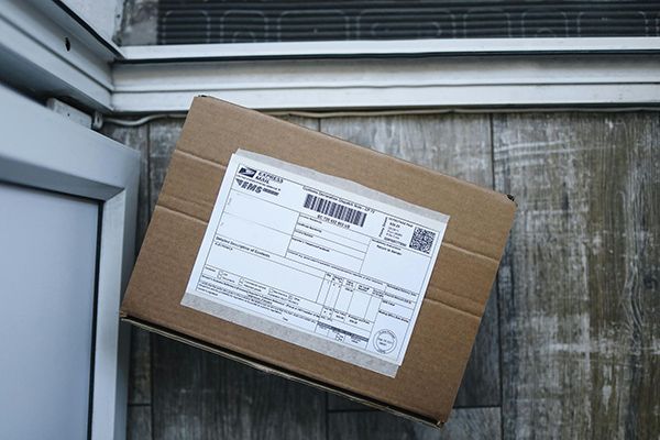brown package on a doorstep waiting to be opened