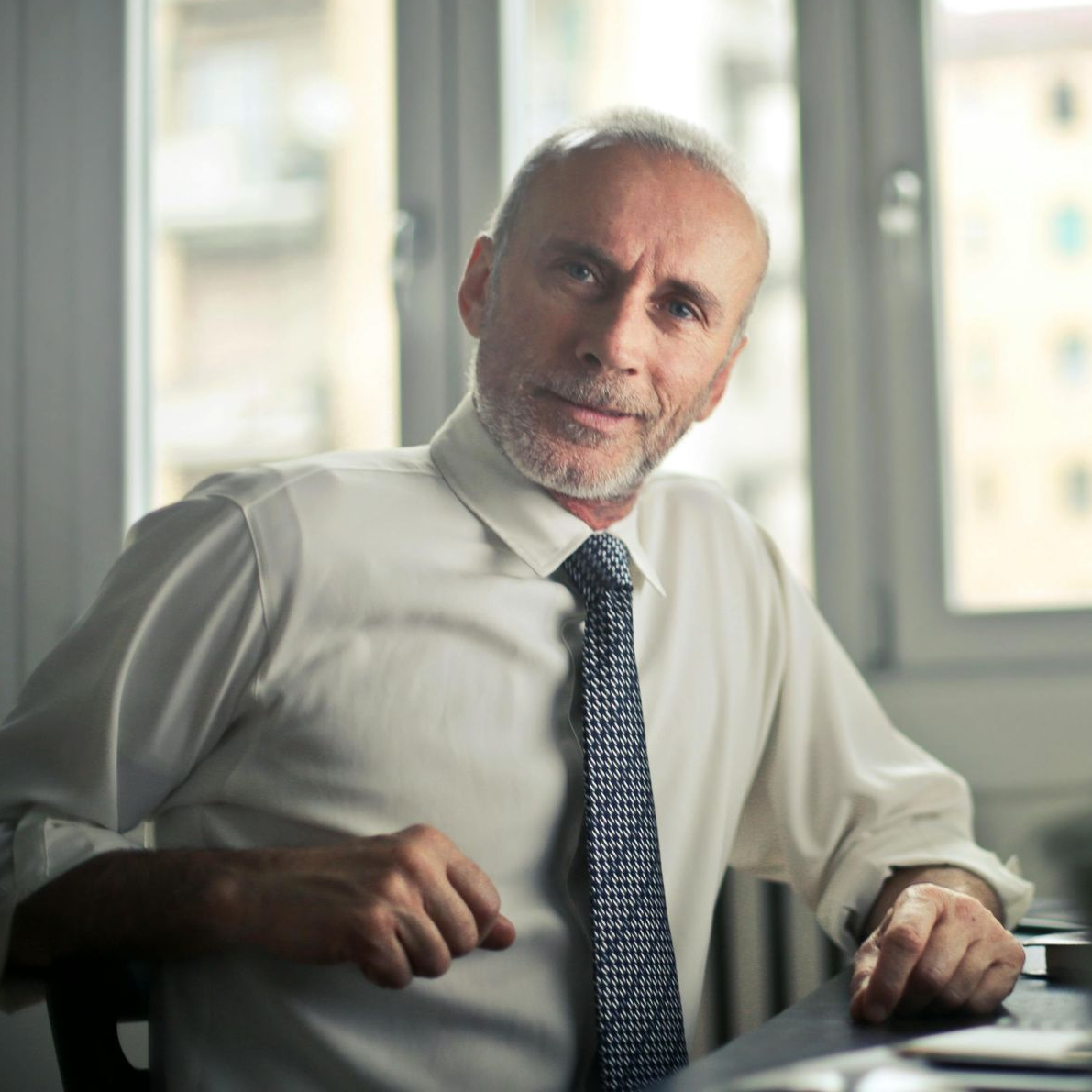 middle aged professional man looking at the camera with a satisfied facial expression