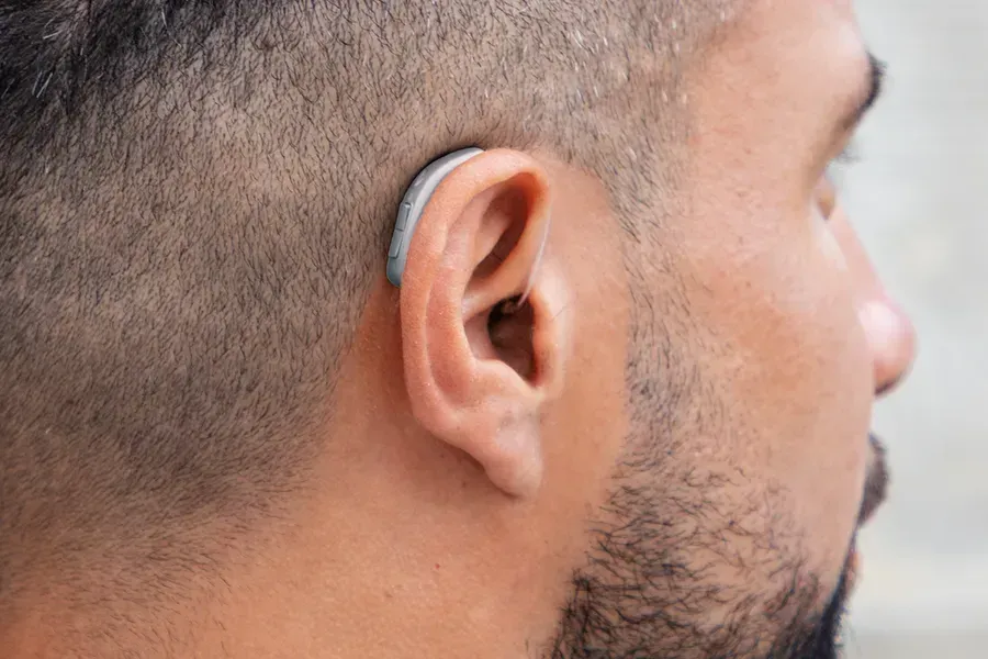 Man with a hearing aid behind his ear