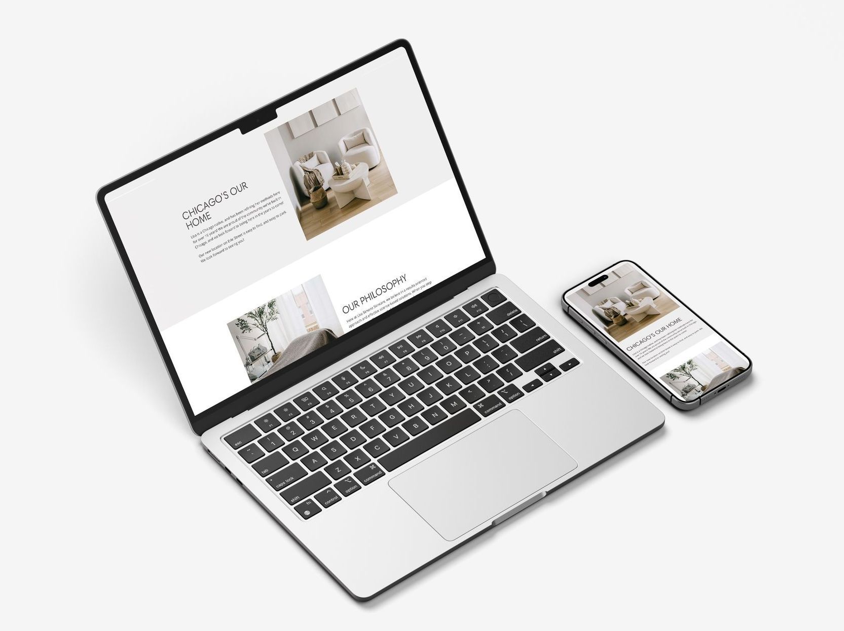 Laptop and phone displaying a website with images of interior design, on a white background.
