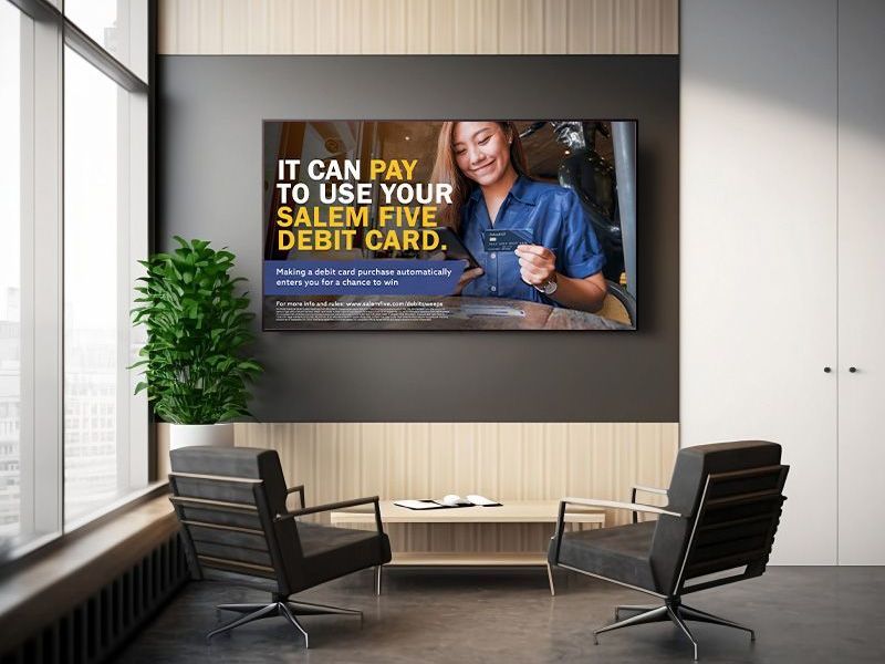 Digital display promoting Salem Five debit card; woman smiling, interior setting.