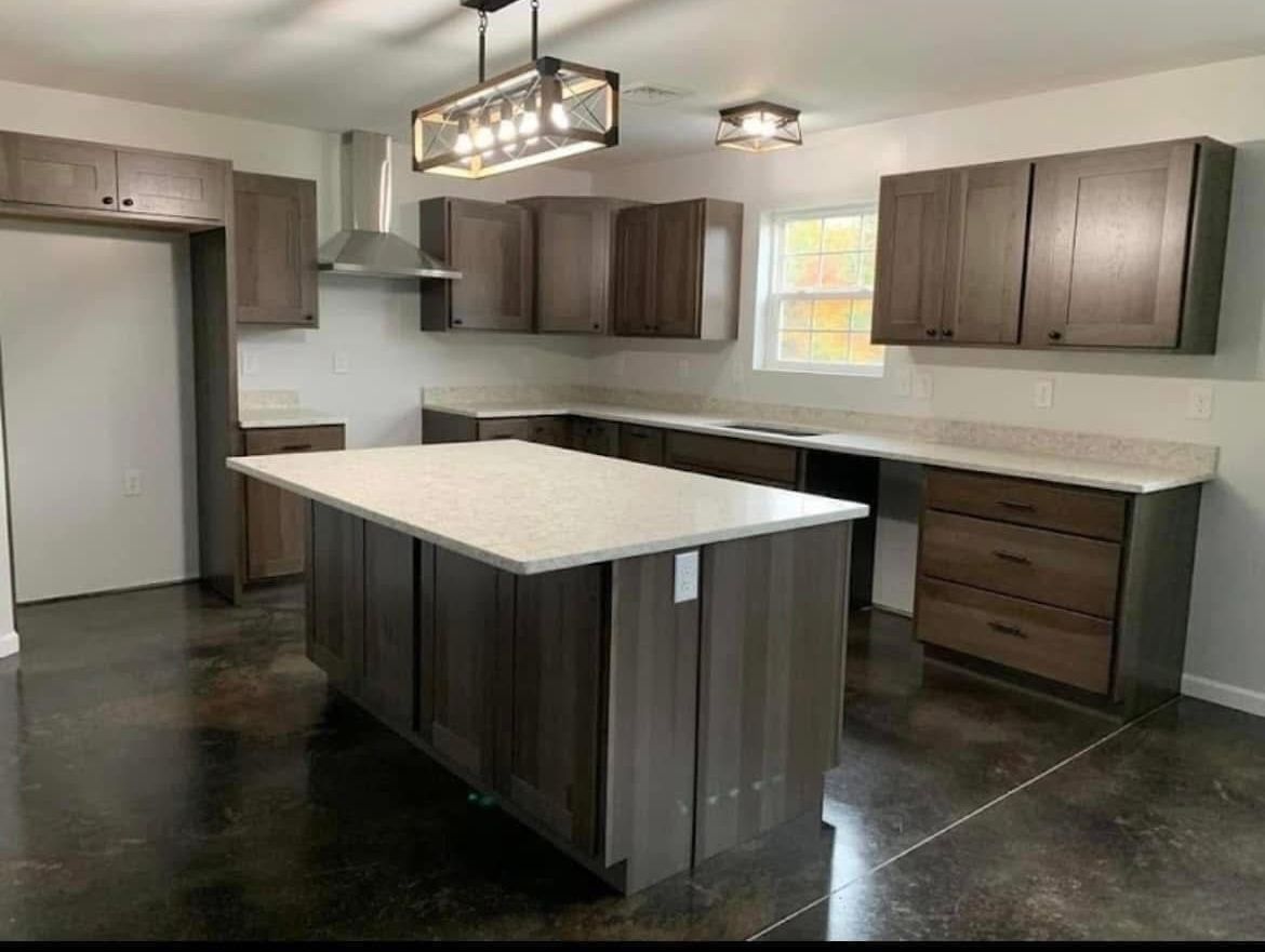 A kitchen with granite counter tops and white cabinets is being remodeled.