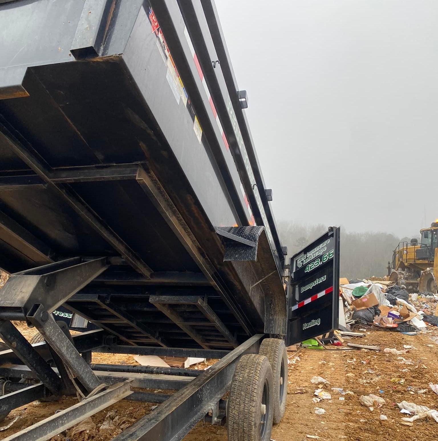 A dump truck is parked in a pile of dirt