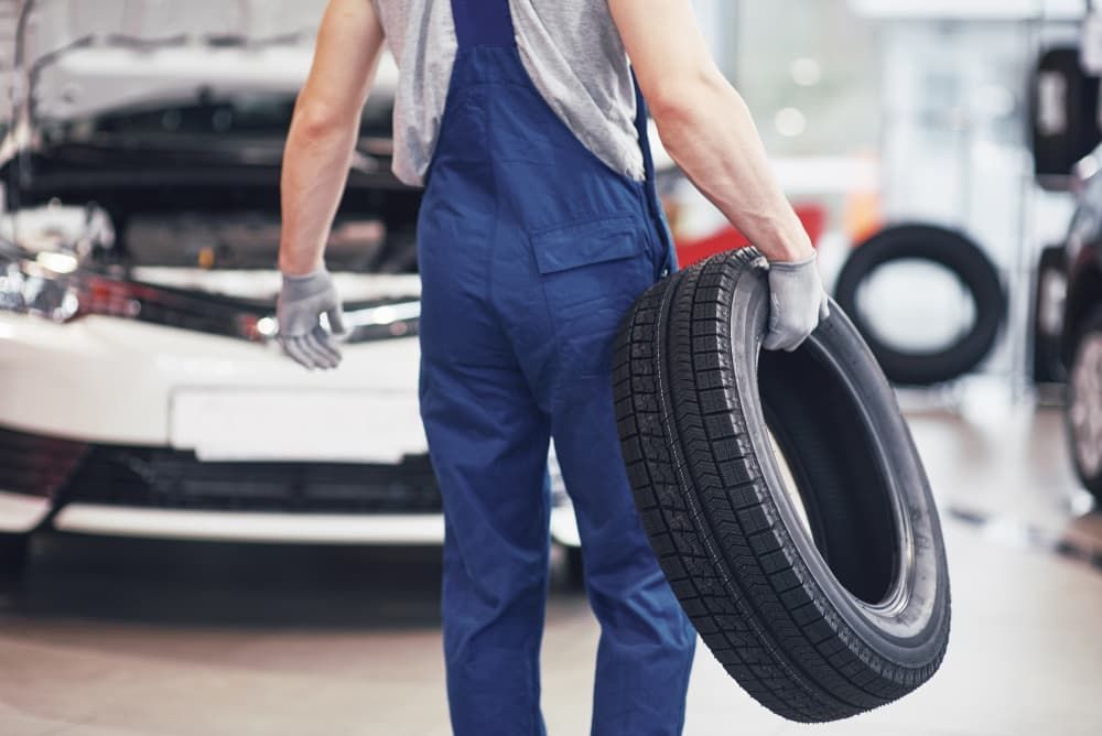 Mechanic Holding Tire - Mechanic in Coffs Harbour, NSW