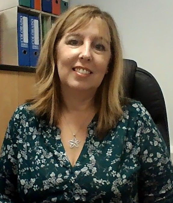 A close up of a woman 's face with a smile on her face