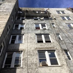 A large building with a lot of windows and a rope hanging from the side of it.