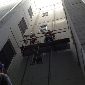 A man is standing on a platform in the middle of a building.