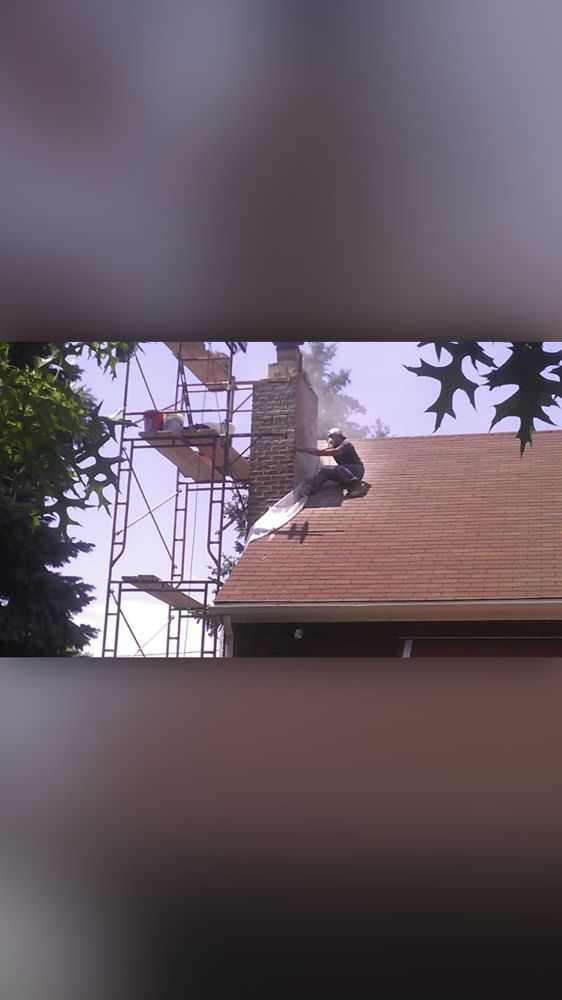 A man is working on the roof of a house