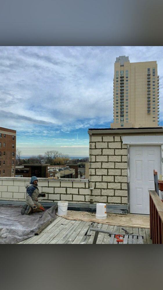 A man is working on the roof of a building.