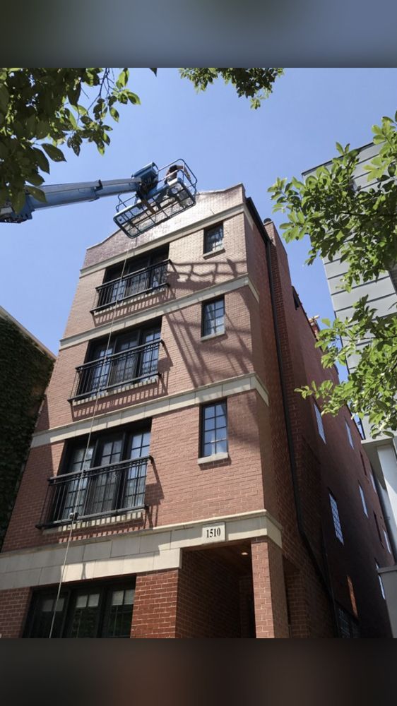 A brick building with a crane on top of it