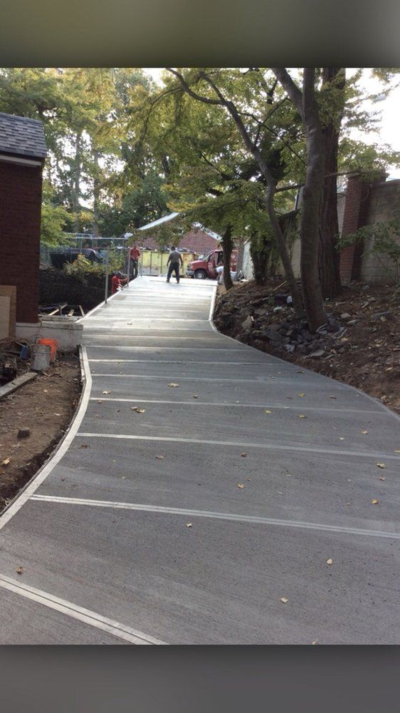 A concrete driveway is being built in a residential area.