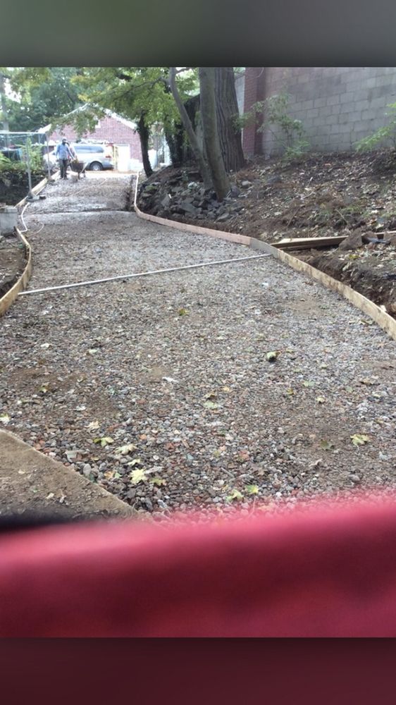 A gravel path is being built in the woods.