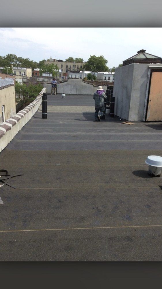 A man is standing on the roof of a building.