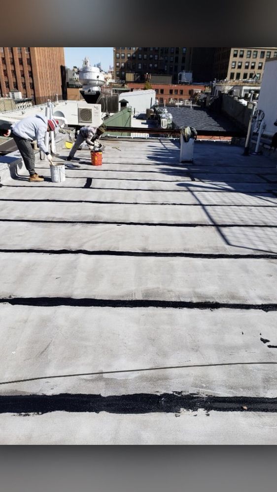 A man is working on the roof of a building.
