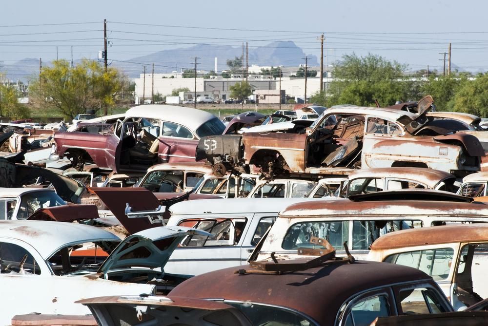 Junk Cars Piled High in A Scrapyard — Jap Performance T/A All Tuggerah City Auto Dismantlers in Bateau Bay, NSW
