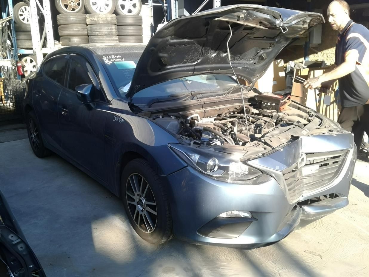 Mazda Hatchback with The Hood Open in A Scrap Yard — Jap Performance T/A All Tuggerah City Auto Dismantlers in Tuggerah, NSW