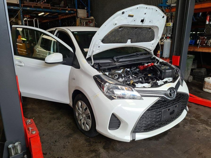 White Toyota Yaris with The Hood in A Repair Shop — Jap Performance T/A All Tuggerah City Auto Dismantlers in Tuggerah, NSW