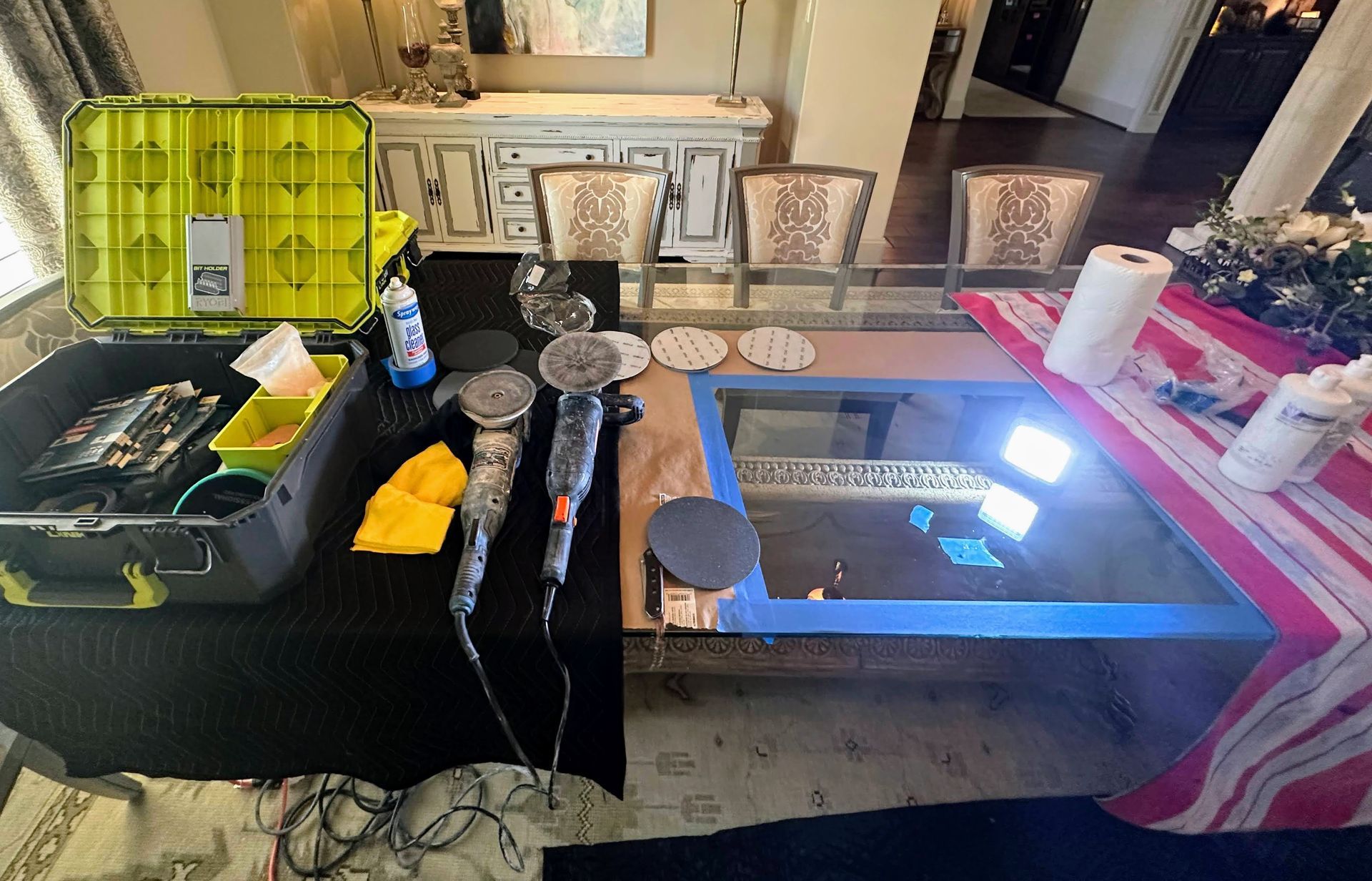 Various hair styling tools and accessories laid out on a table, with a mirror and grooming station