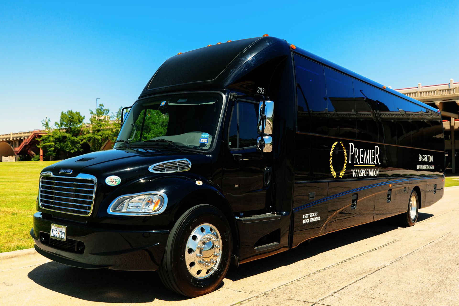 A large black bus is parked on the side of the road.