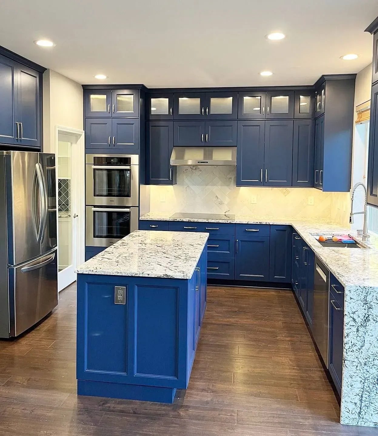 A kitchen with blue cabinets and granite counter tops