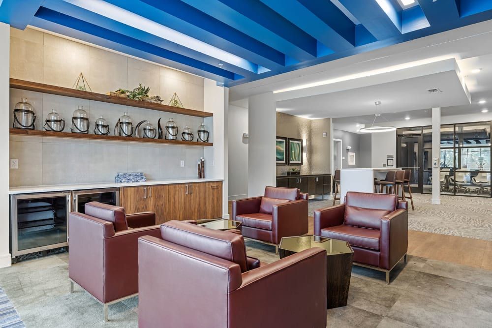 A living room filled with furniture and a blue ceiling at Water's Edge.
