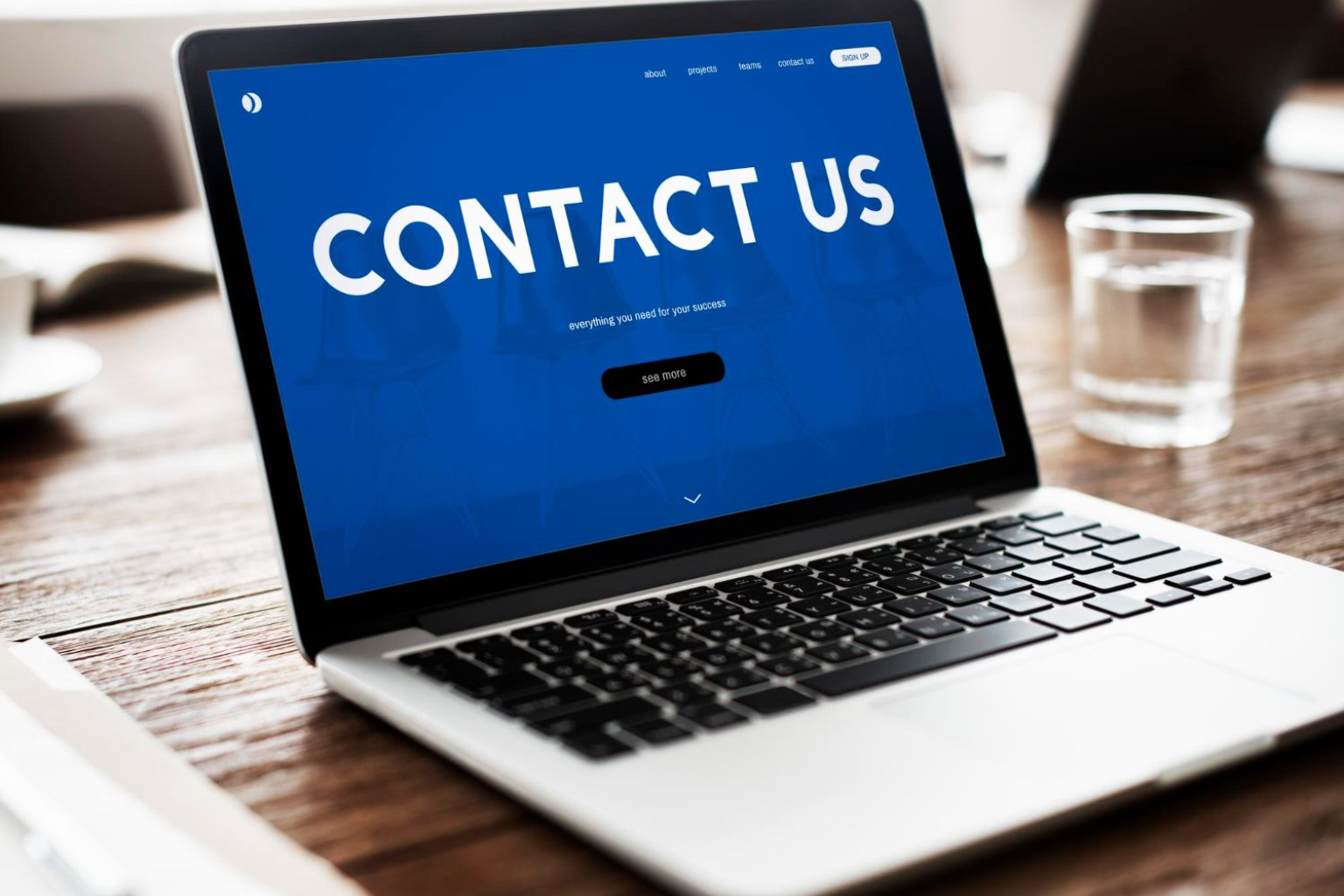 laptop showing the words Contact Us