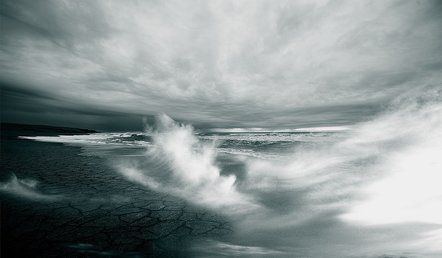 Stormy ocean waves crashing under a dark, cloudy sky