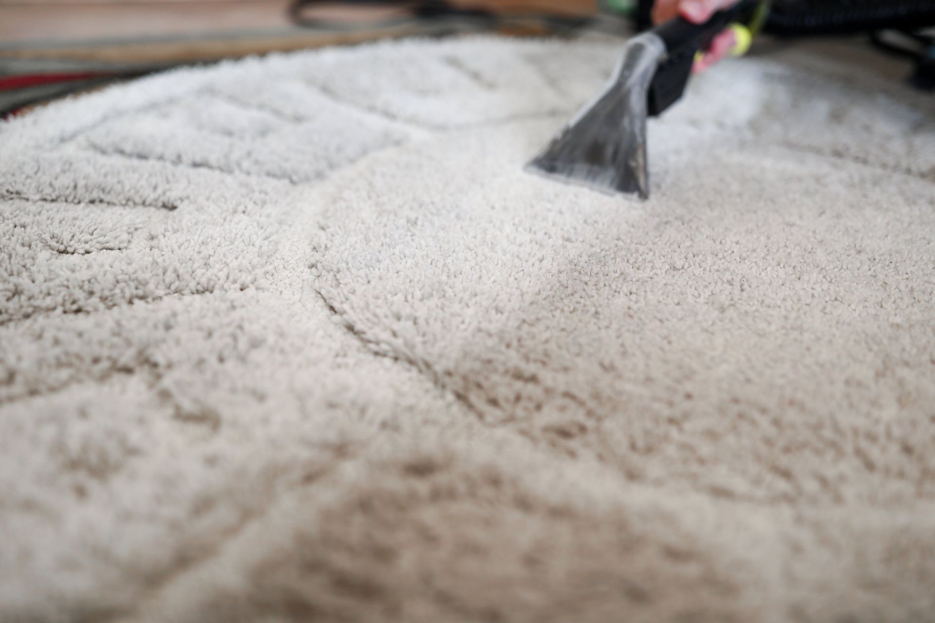 Hands using a tool to smooth white powder across a surface