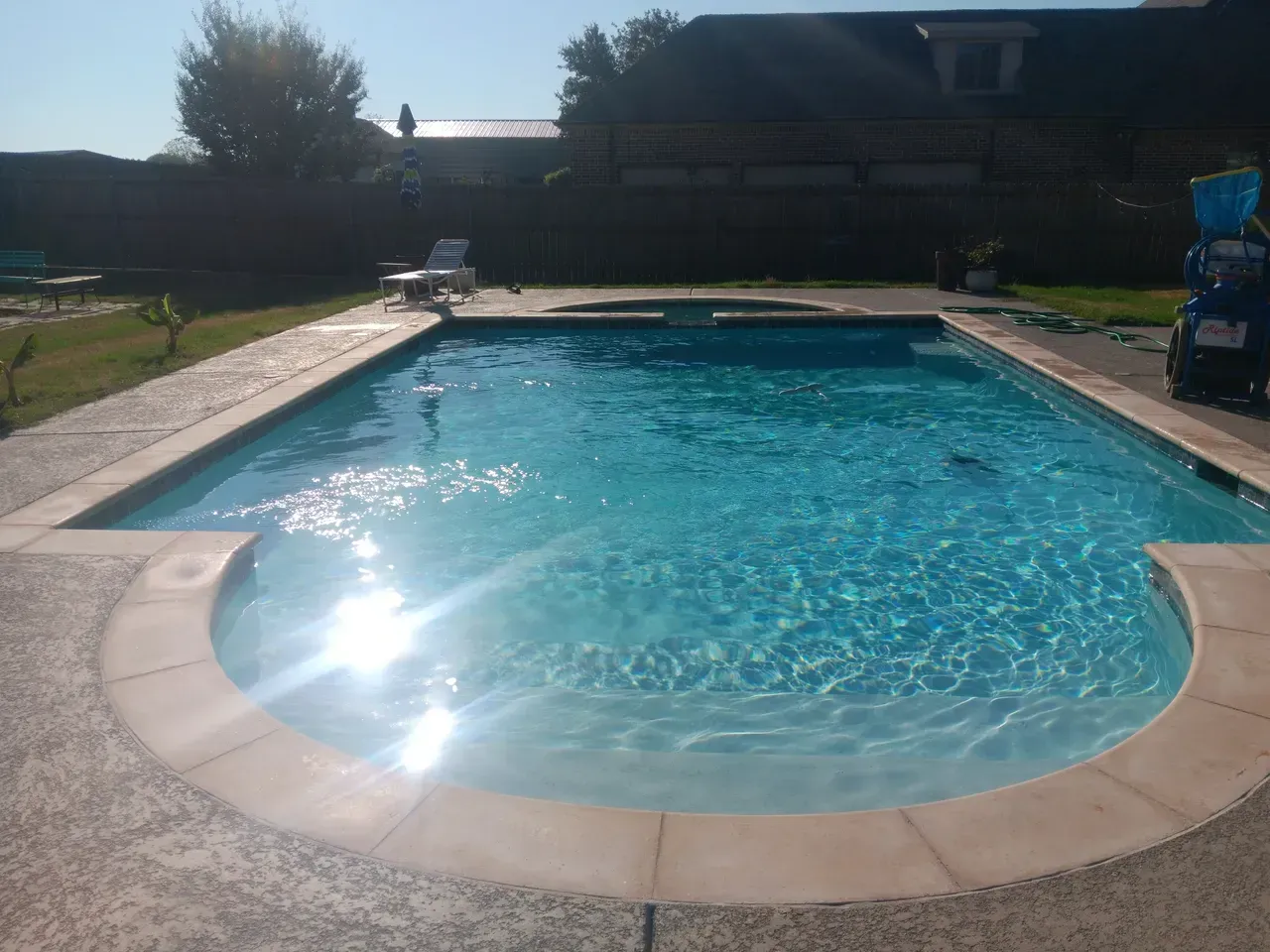 A large swimming pool in the backyard of a house