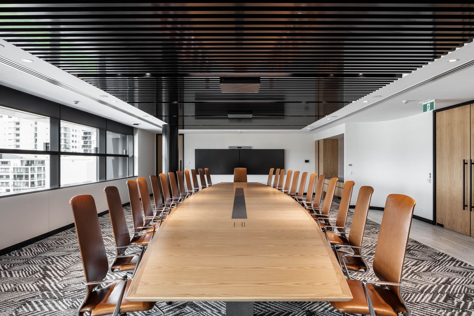 A wooden table in an office with lots of chairs — Marlix Custom Timber Furniture Design and Joinery in Unanderra, NSW