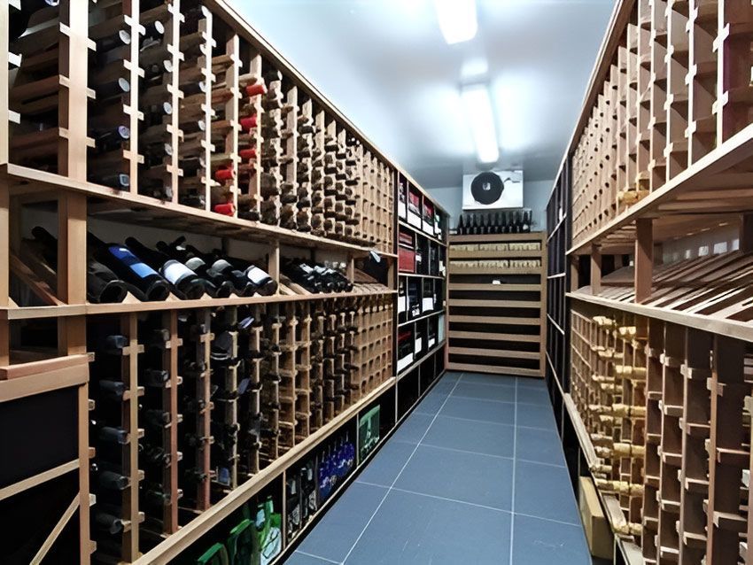 A Wooden Wine Cellar Filled With Lots Of Bottles Of Wine — Marlix Custom Timber Furniture Design and Joinery in Thirroul, NSW