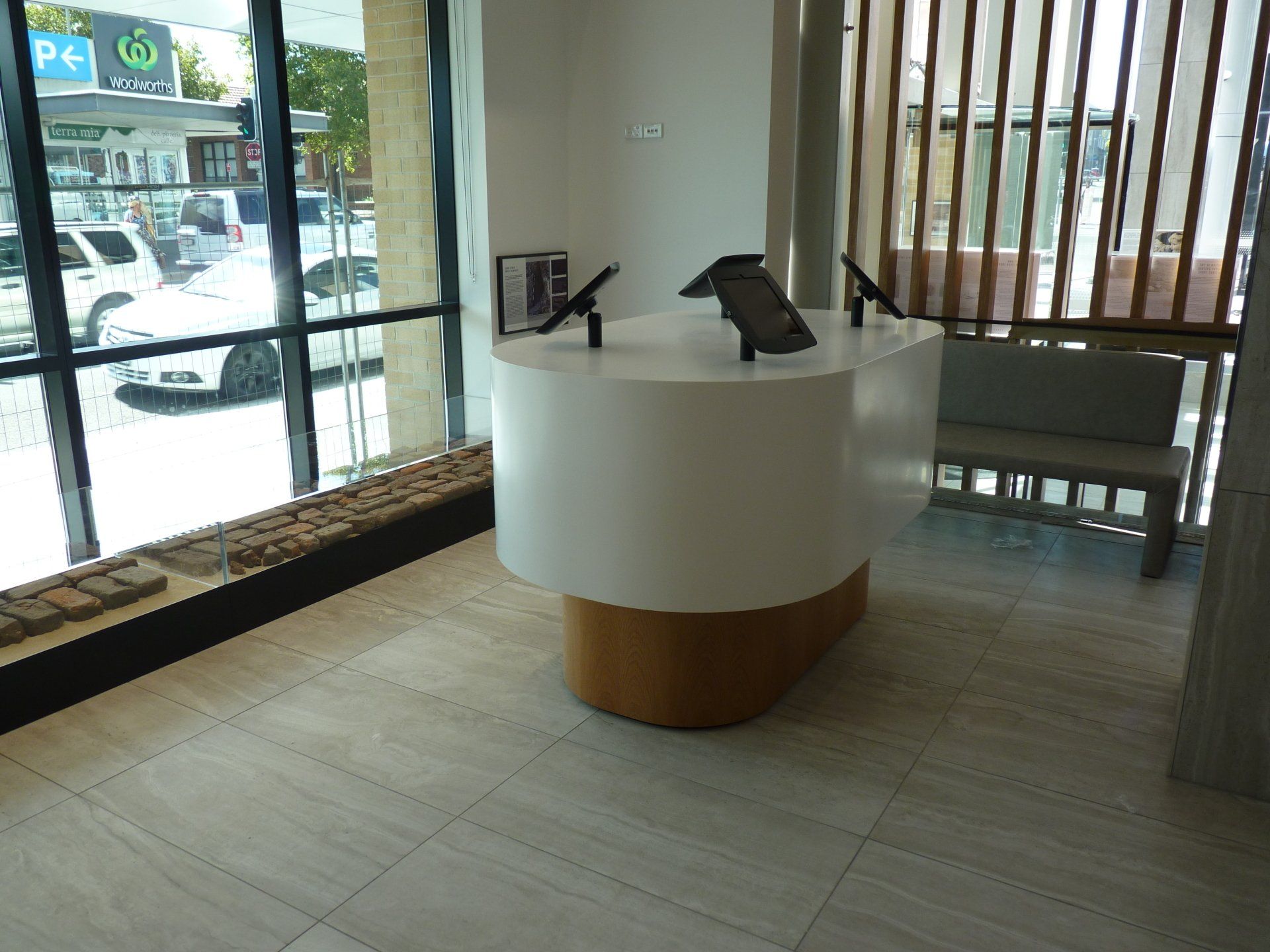 A White Counter in A Room with A Bench and A Window — Marlix Custom Timber Furniture Design and Joinery in Unanderra, NSW