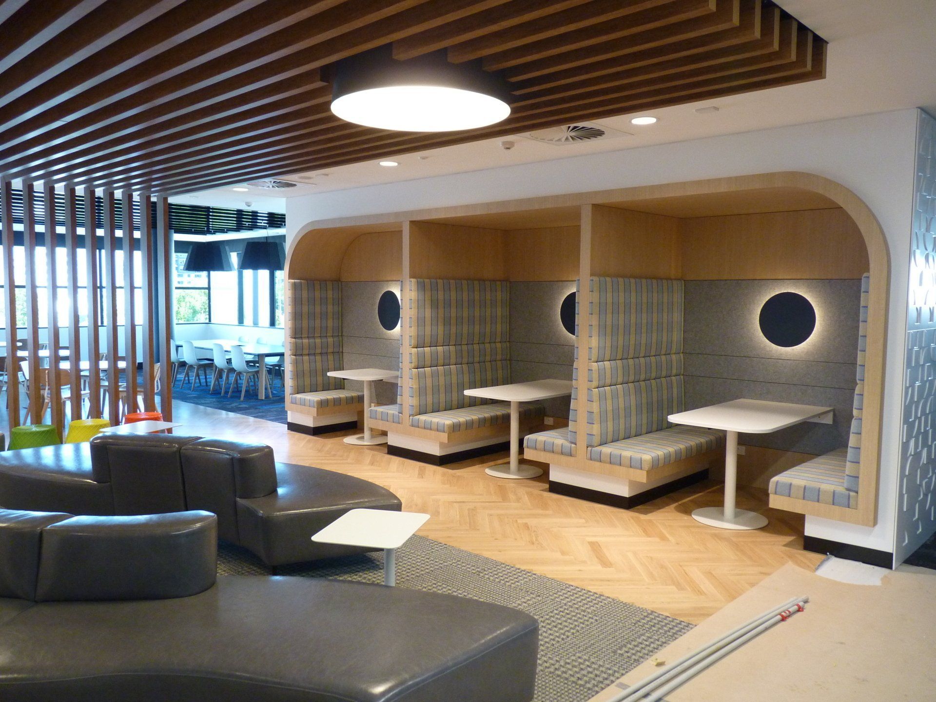 A living room with a lot of furniture and tables — Marlix Custom Timber Furniture Design and Joinery in Unanderra, NSW