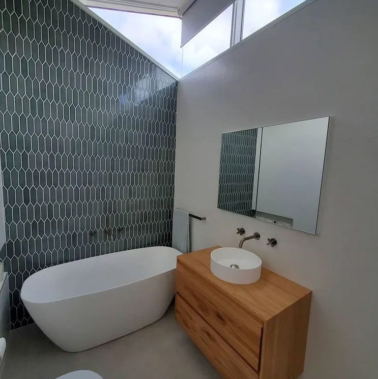 A Bathroom With A Bathtub And Wooden Cabinet — Marlix Custom Timber Furniture Design and Joinery in Southern Highlands, NSW
