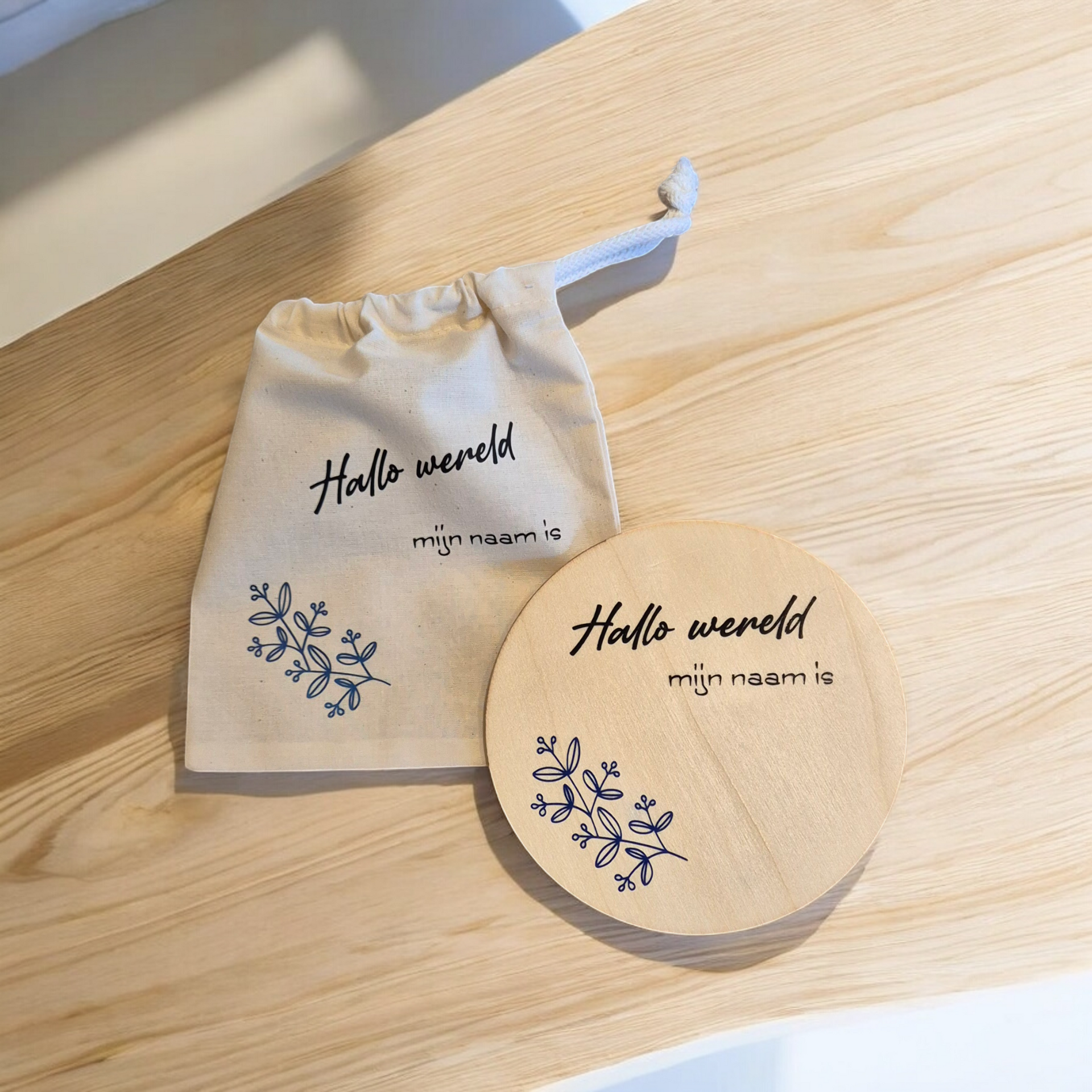 Two wooden discs with blue floral designs and text: