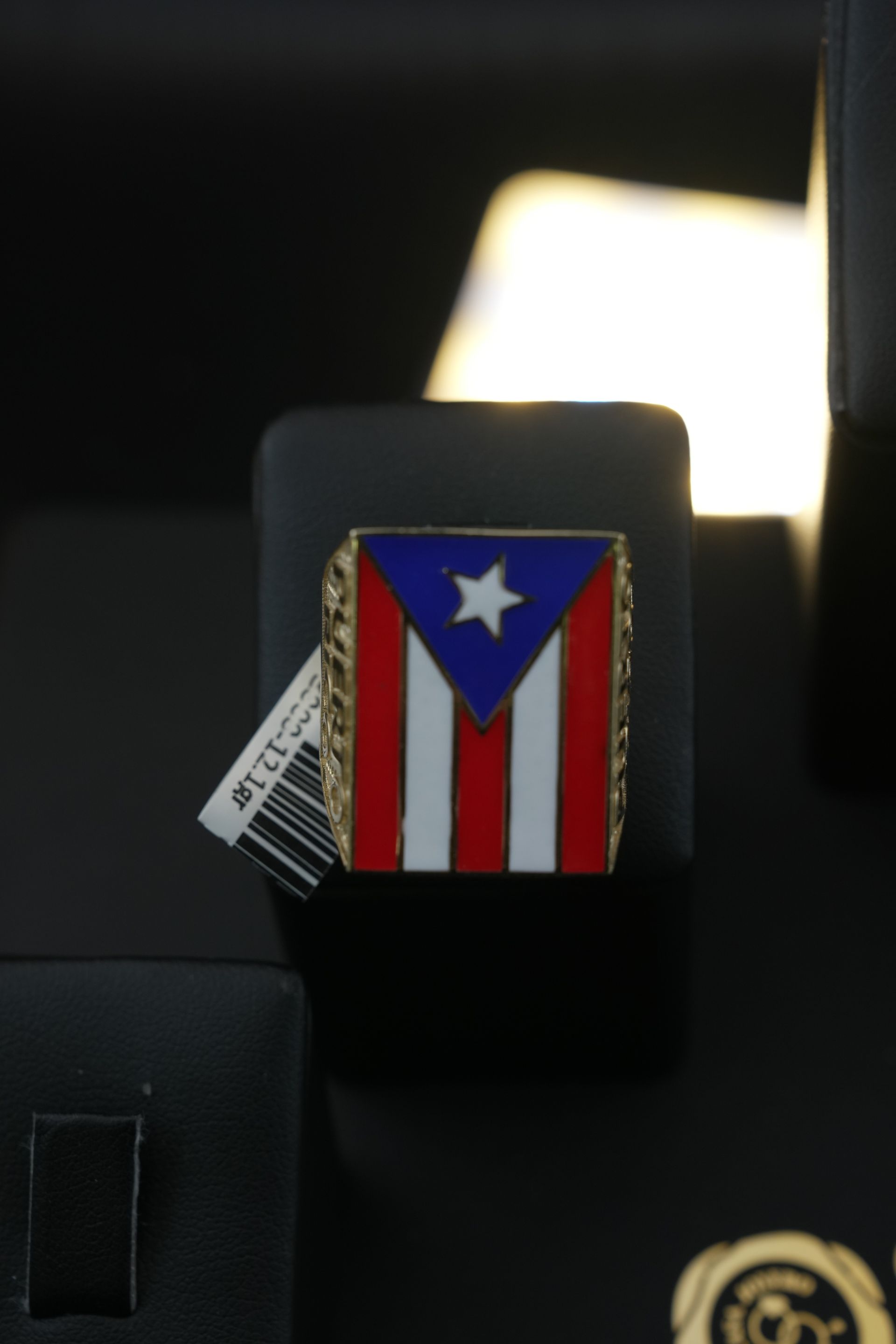 Ring with Puerto Rican flag on display.