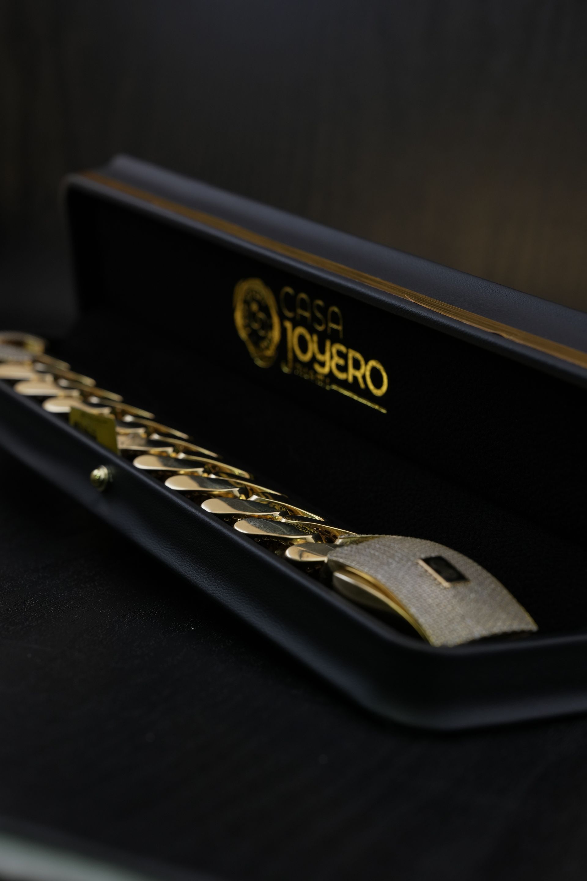 Gold bracelet in a black jewelry box with