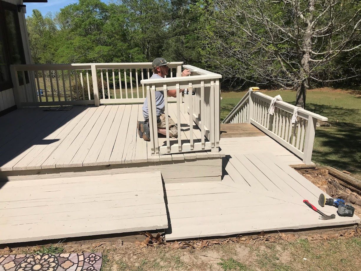 Professional contractor painting and staining a deck.