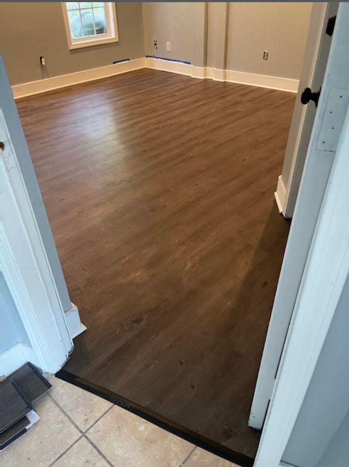 Building contractors installing a vinyl floor.
