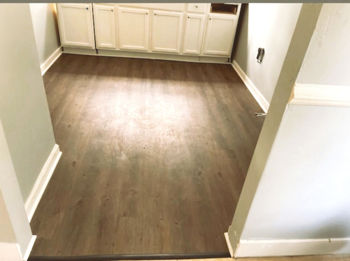 Professional contractor installing a wood floor.