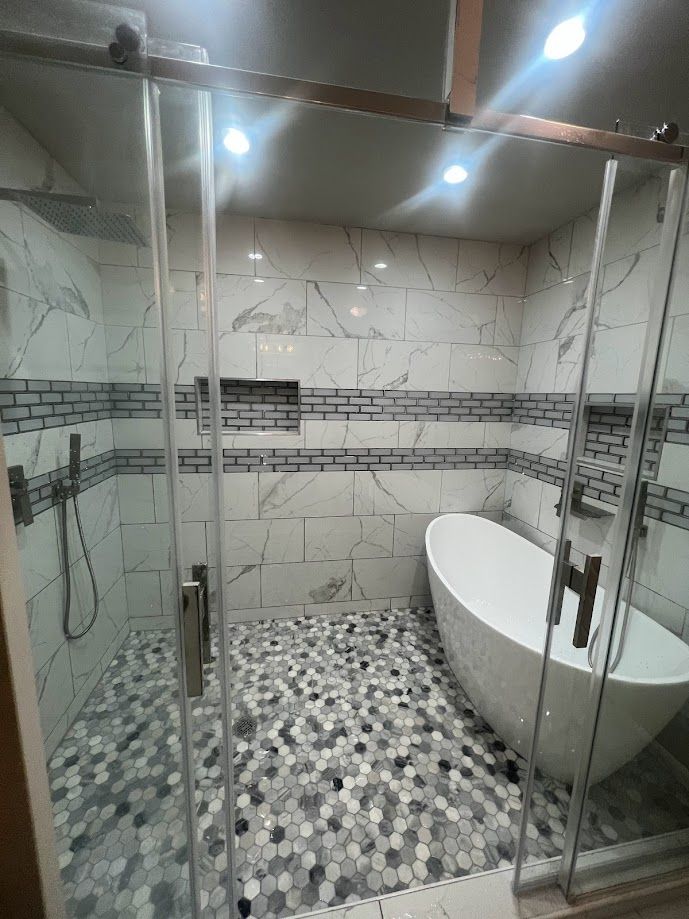 Contractor installing tile in a remodeled bathroom.