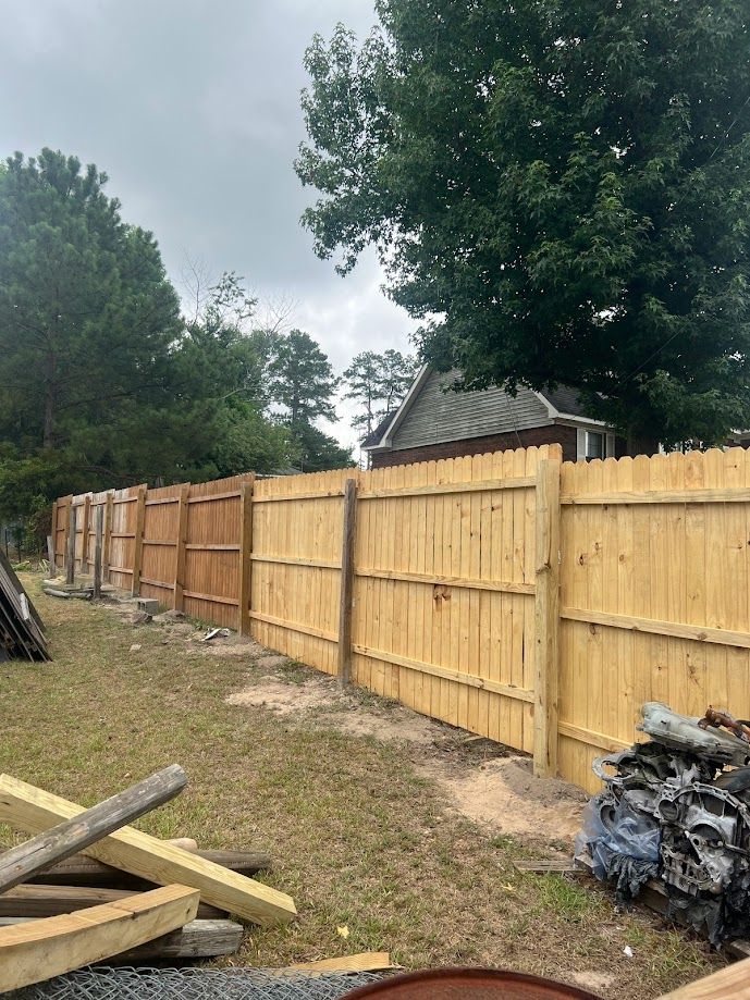 Professional fence builders building a fence.