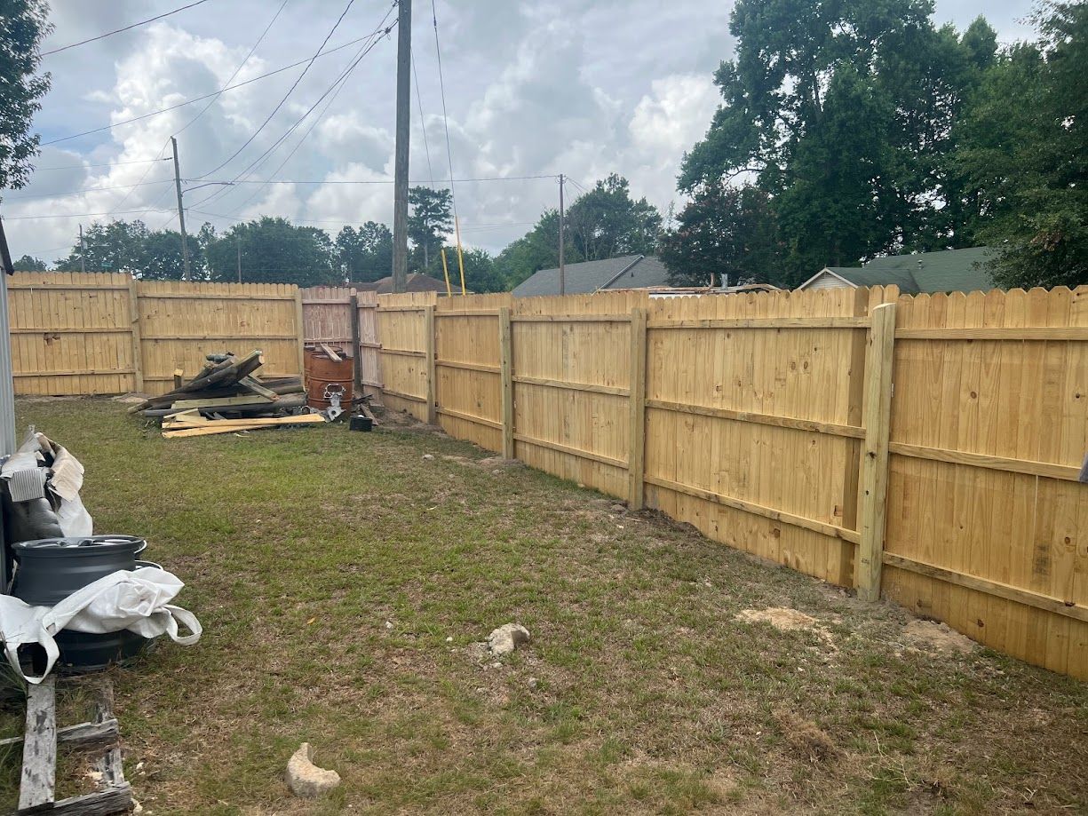 Professional contractor installing a wood fence.