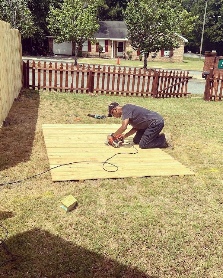 Building contractors installing a wood fence.