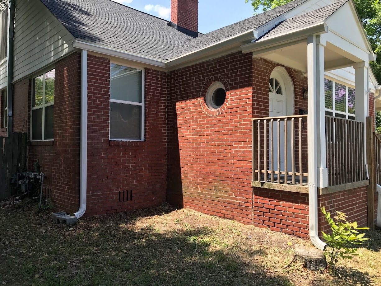Professional contractor installing siding and gutters.